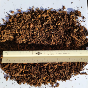 Red Humus with fine, reddish-brown organic matter, spread with a ruler for size reference.