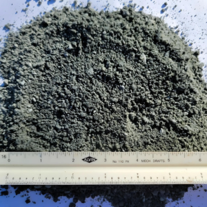 Close-up image of decomposed granite spread out with a ruler for scale.
