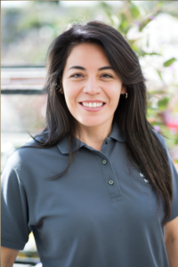 Lucia Martinez, Wholesale and Retail Sales representative at Green Hills Nursery, smiling and wearing a gray polo shirt.